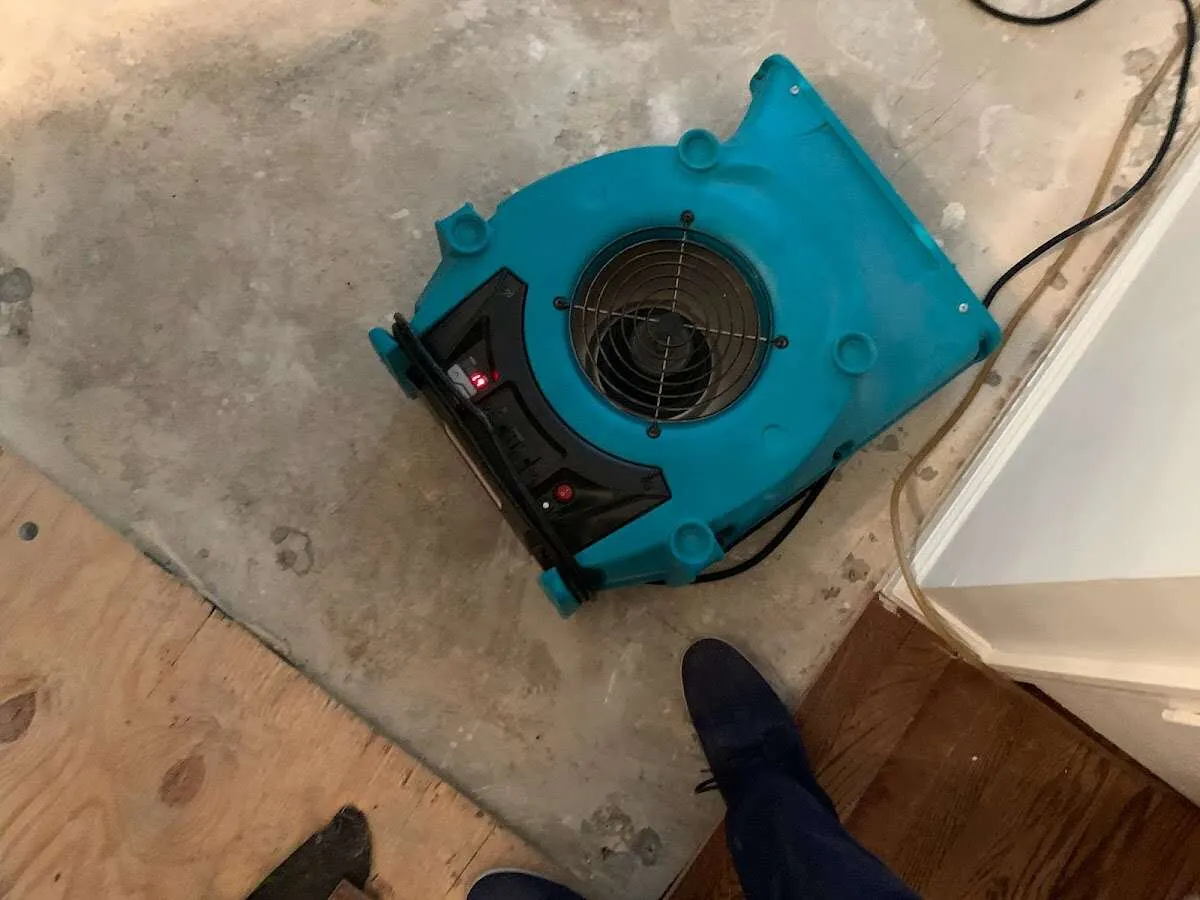 Air mover drying subfloor during Leak Detection & Repair in Fairmount